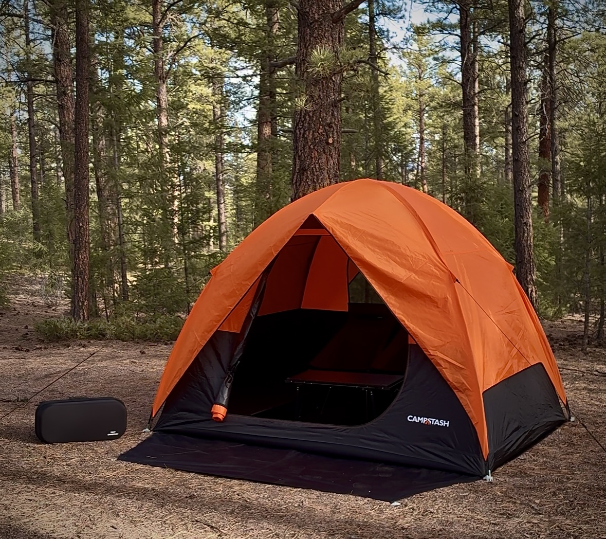 Campstash founder sitting in front of the tent with arms wide open
