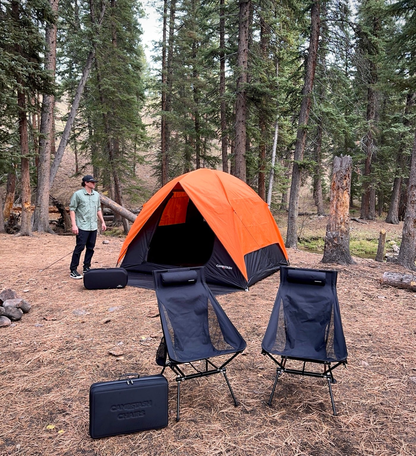 Campstash Tent, two chairs, tent case and chair case together at a real campsite
